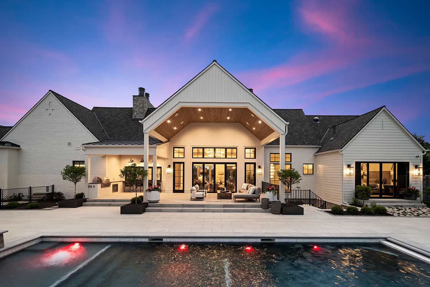european style home exterior patio with a pool