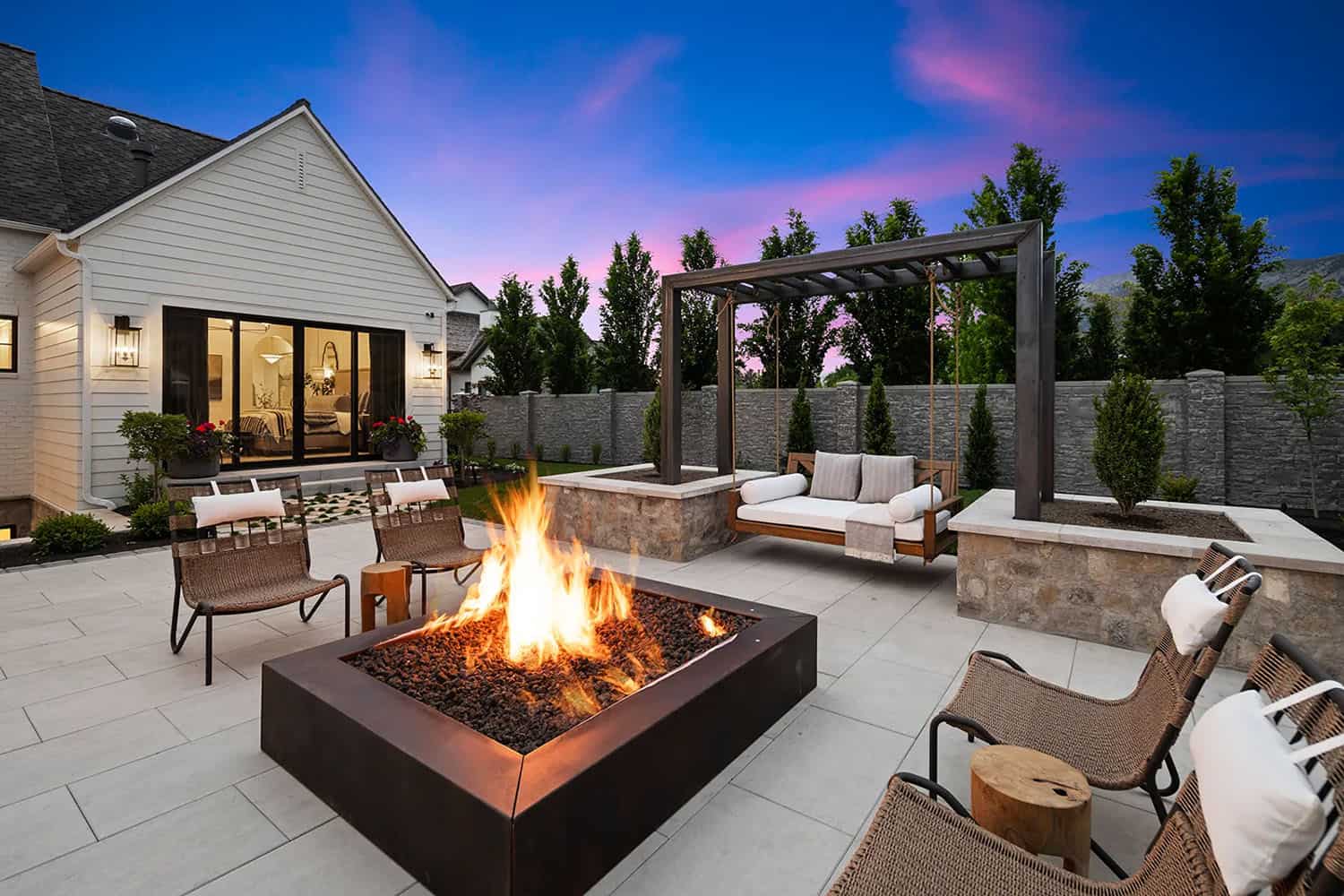 european style home exterior patio with a fire pit and pool