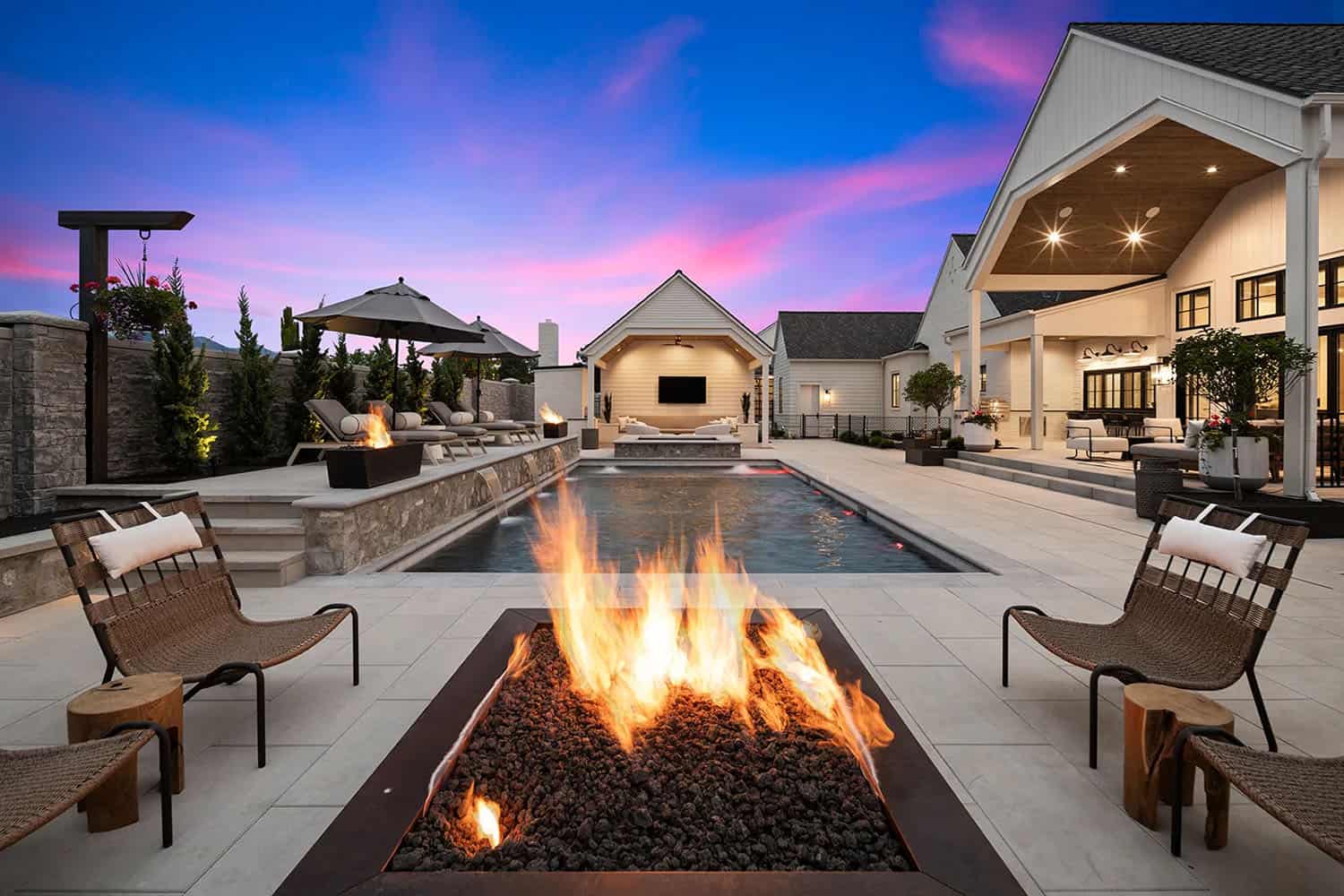 european style home exterior patio with a fire pit and pool