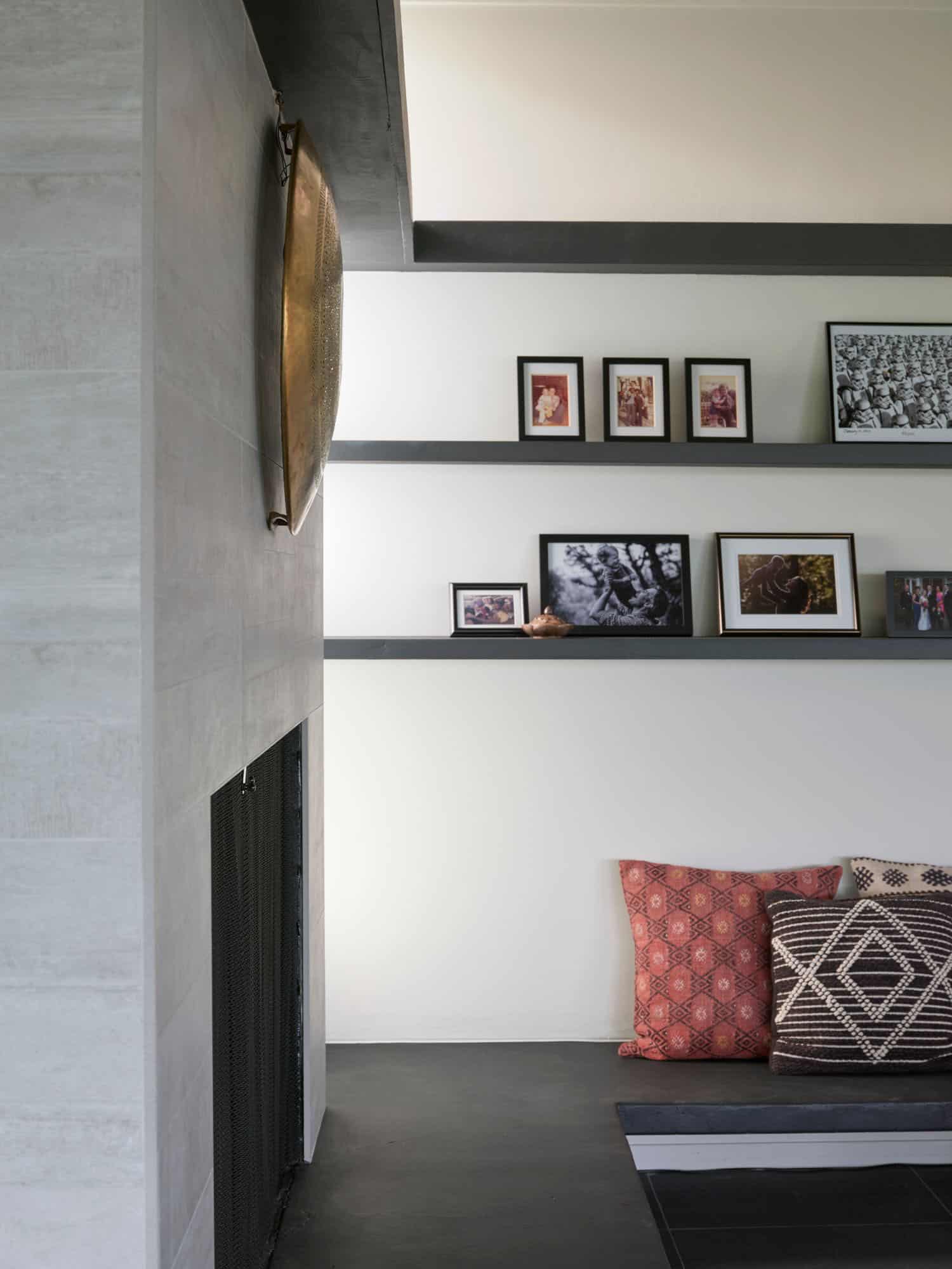 midcentury modern living room with a fireplace and floating shelves