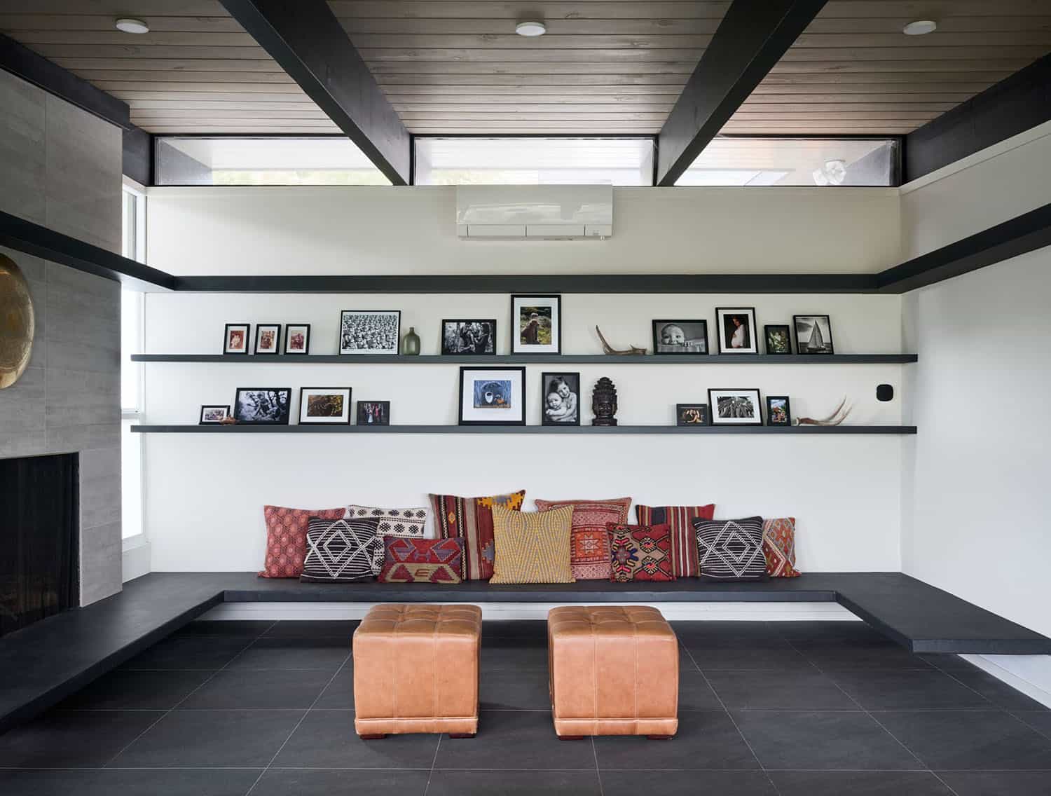 midcentury modern living room with a fireplace and floating shelves