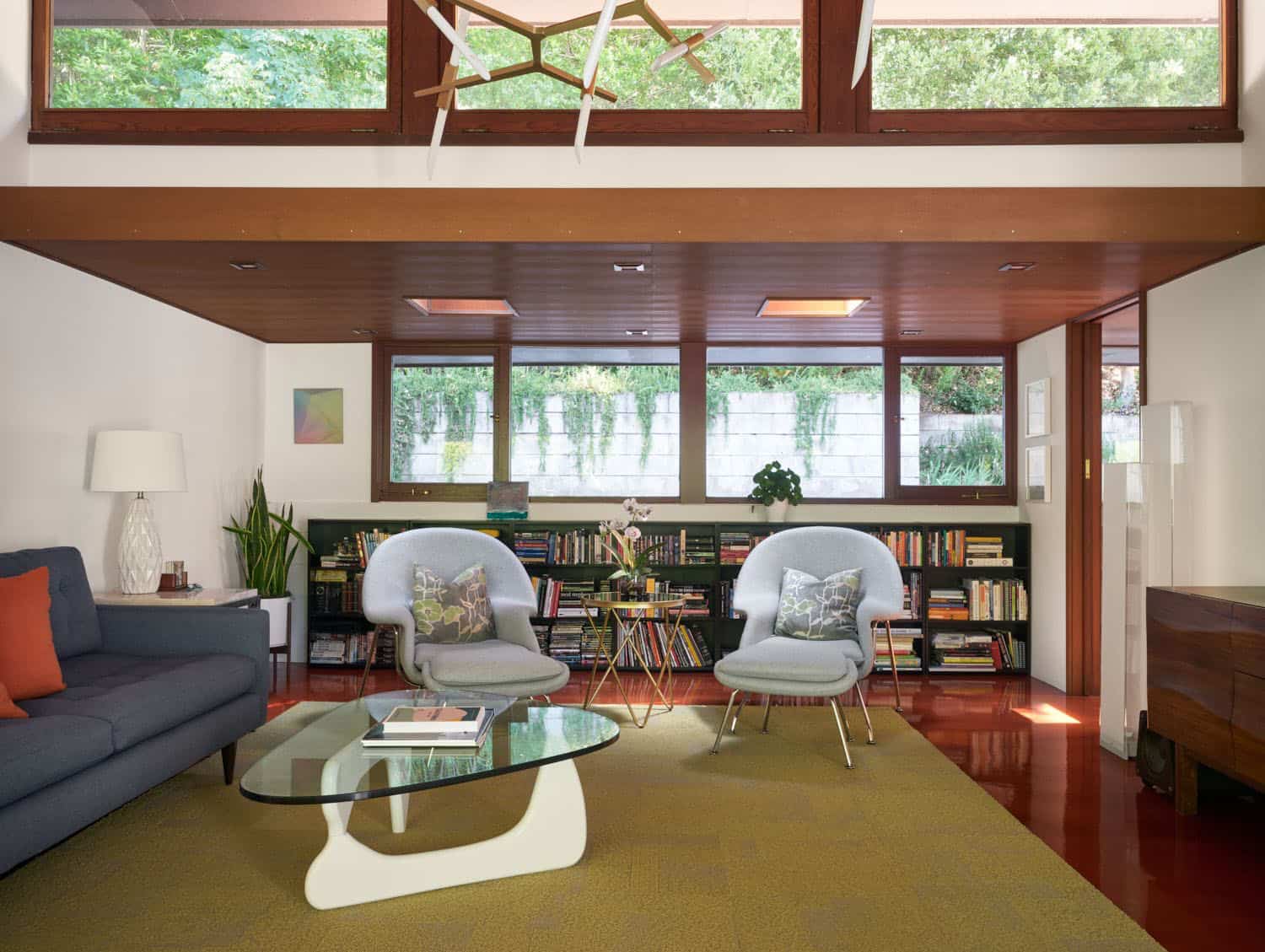 midcentury modern home library with bookshelves and a nagouchi table