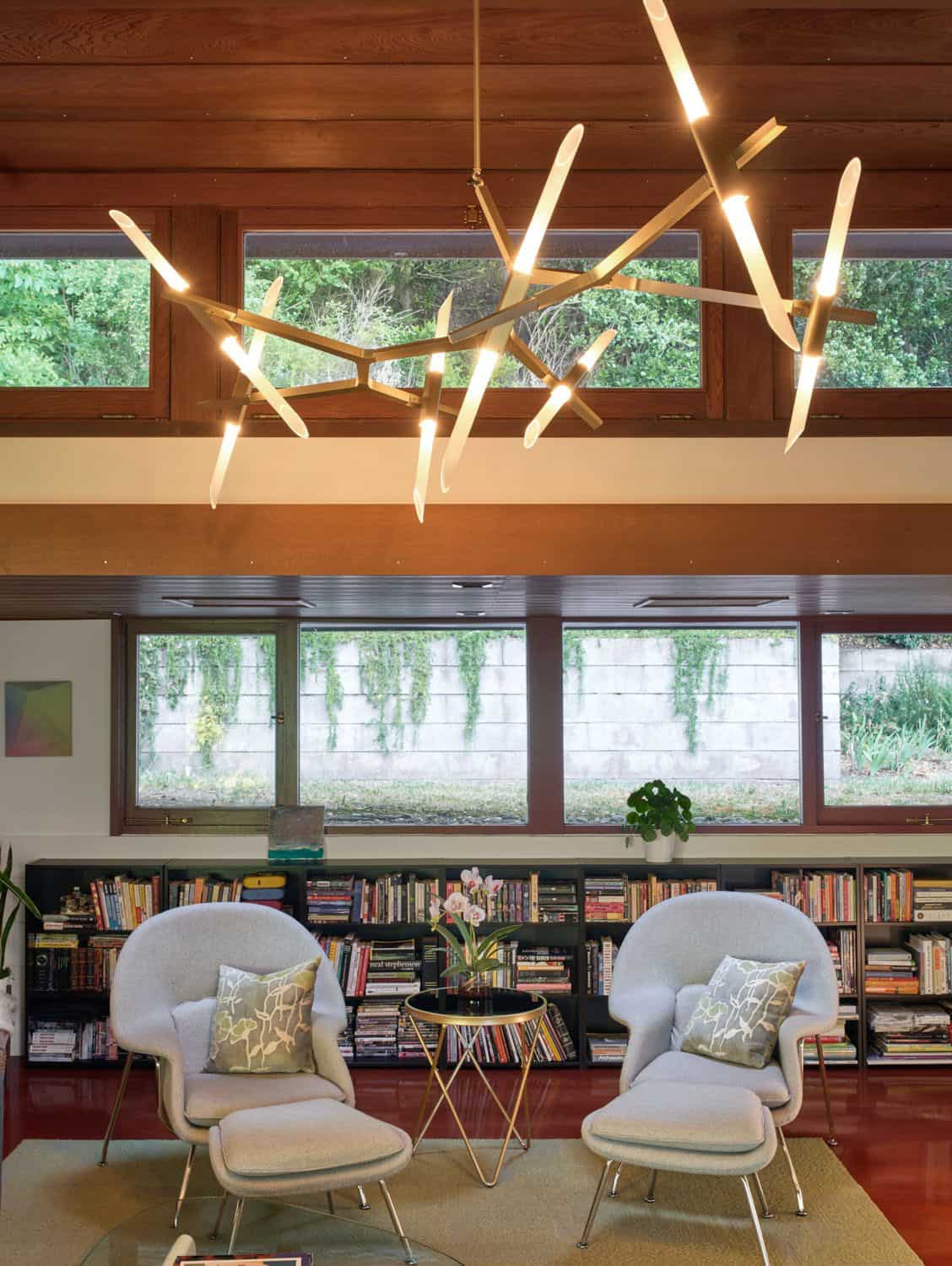 midcentury modern home library with bookshelves and two chairs