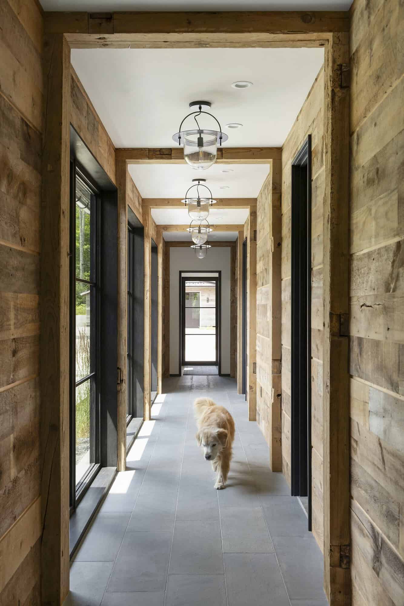 rustic hallway with pendant lights and a dog