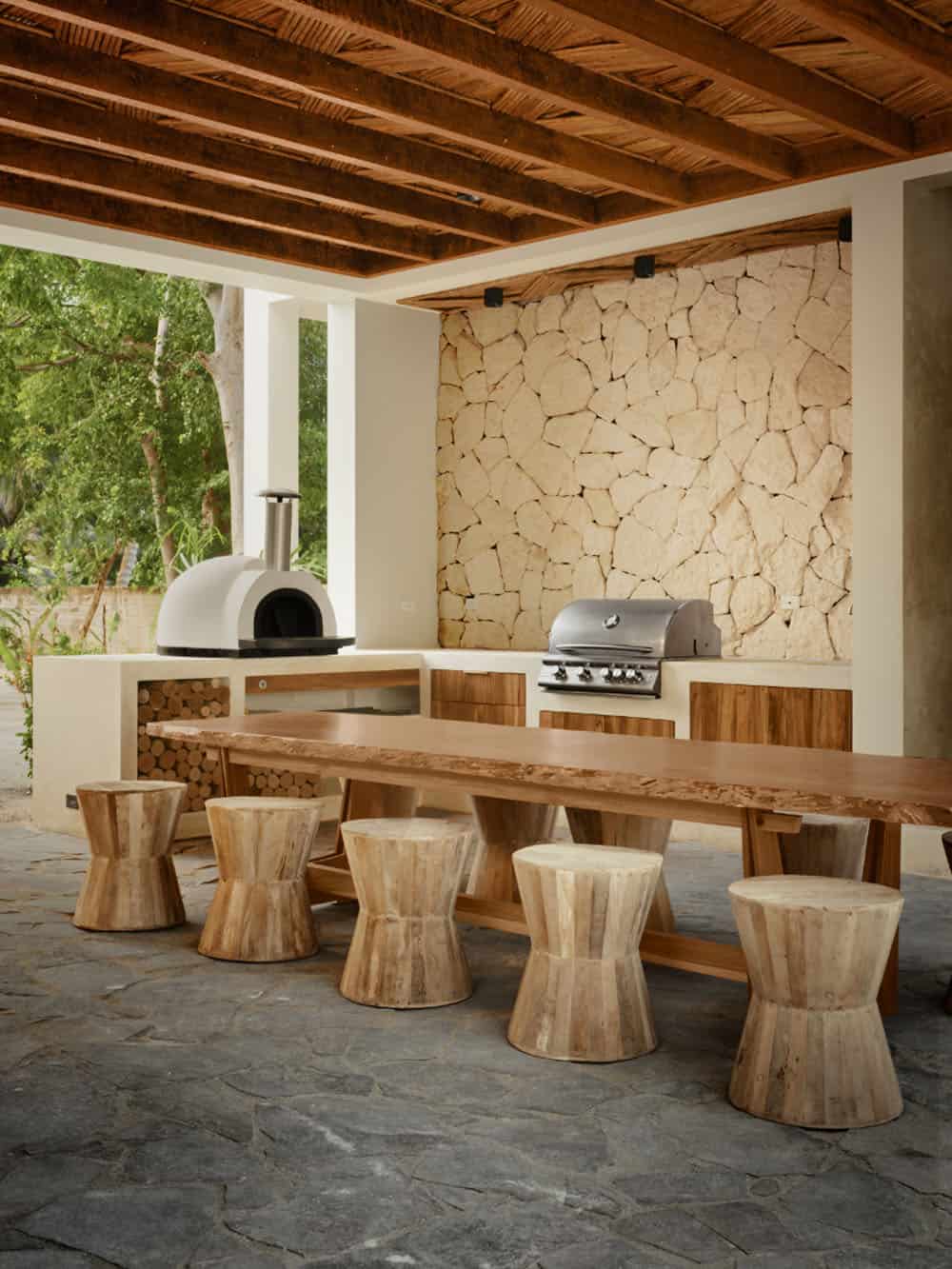modern coastal home covered patio with an outdoor kitchen