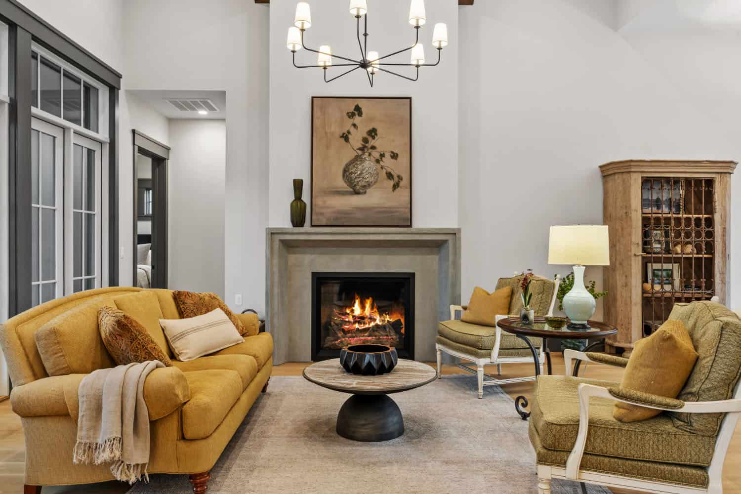 A living room with yellow sofas and a fireplace.