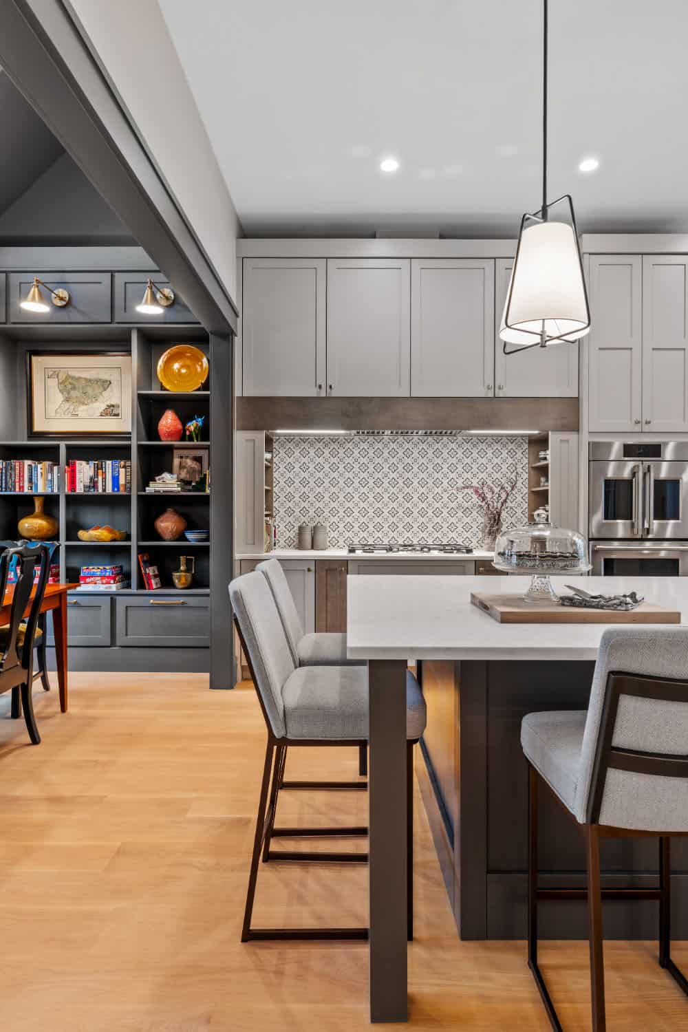 A kitchen with a center island and wooden floors.