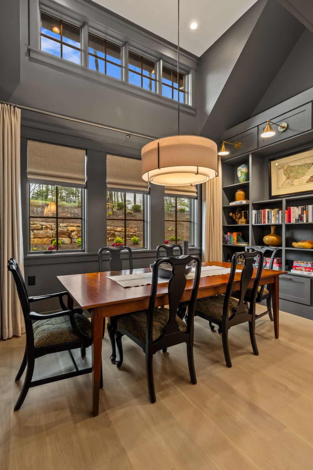 A hallway with a staircase and a bookcase.