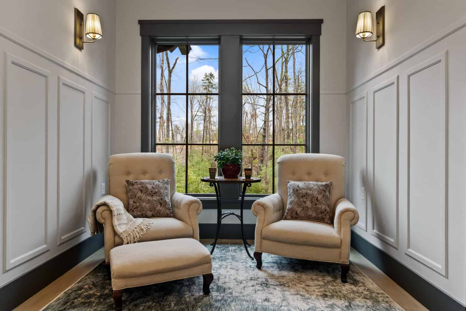 hallway sitting area with two chairs and a large window
