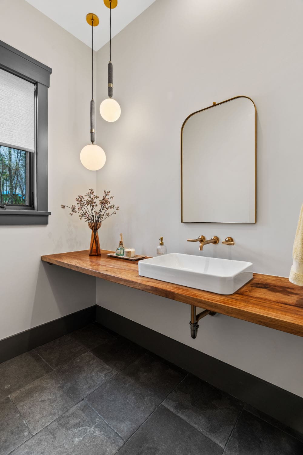modern powder room with a floating vanity and sink