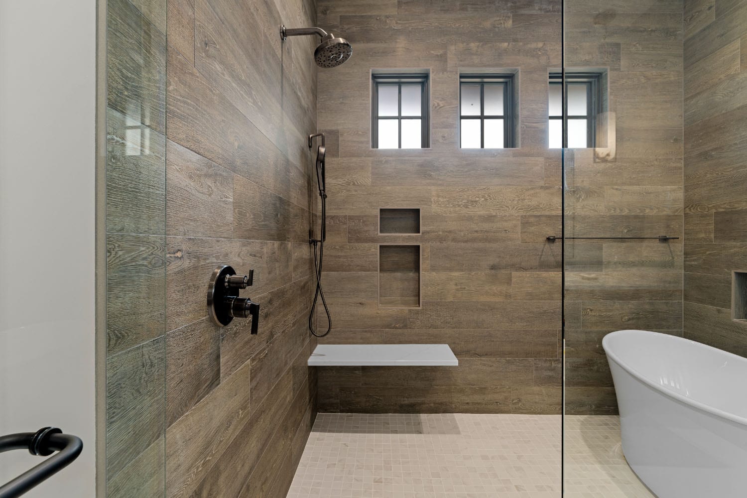 modern walk in shower with a freestanding tub