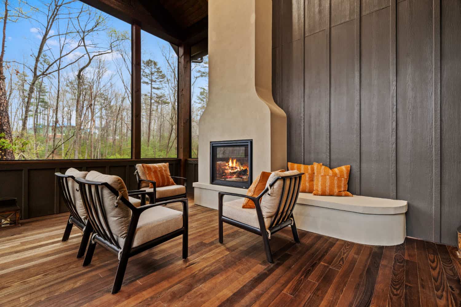 modern screened porch with a fireplace and built-in bench