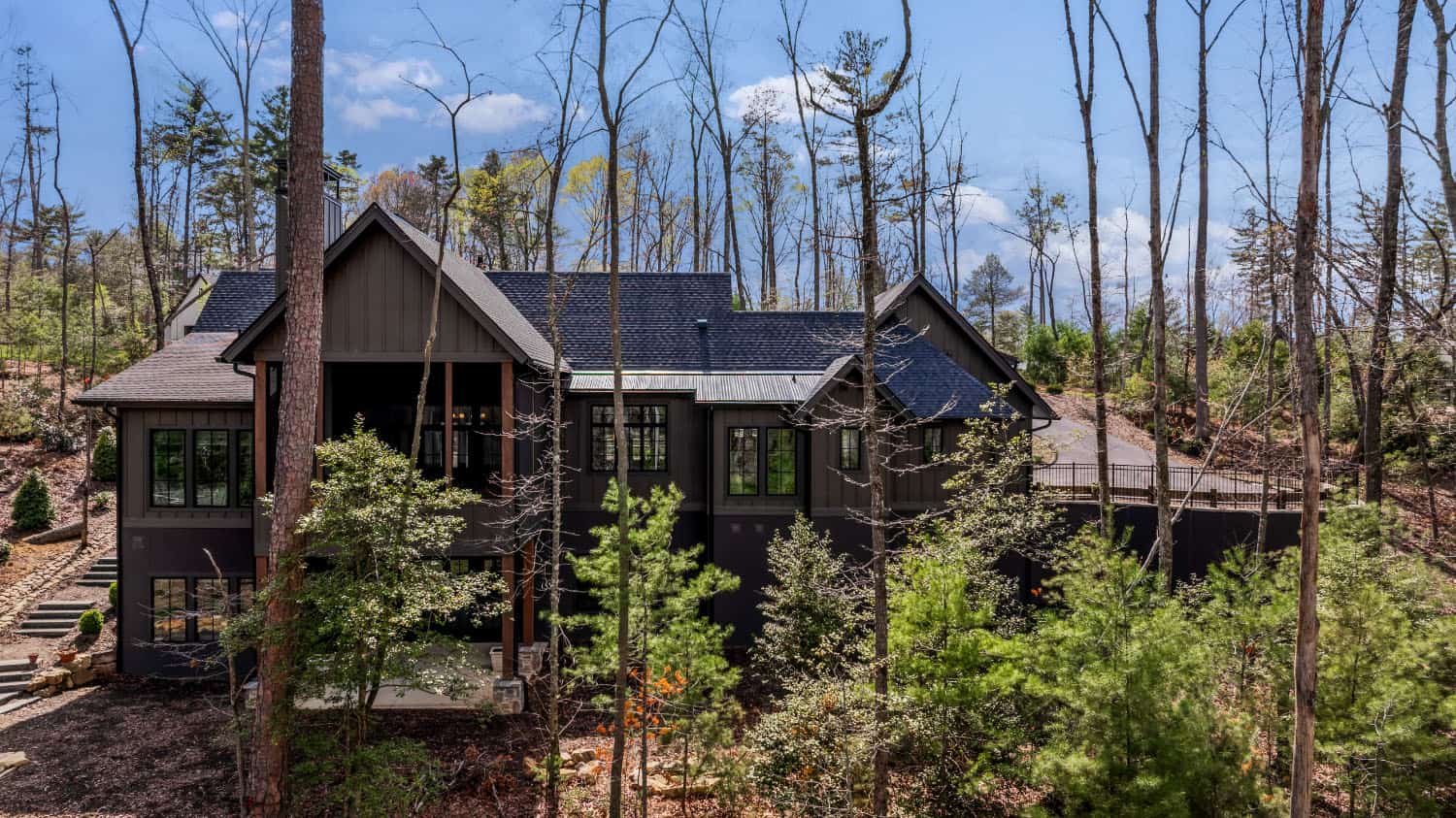 modern cottage style home exterior with a forest