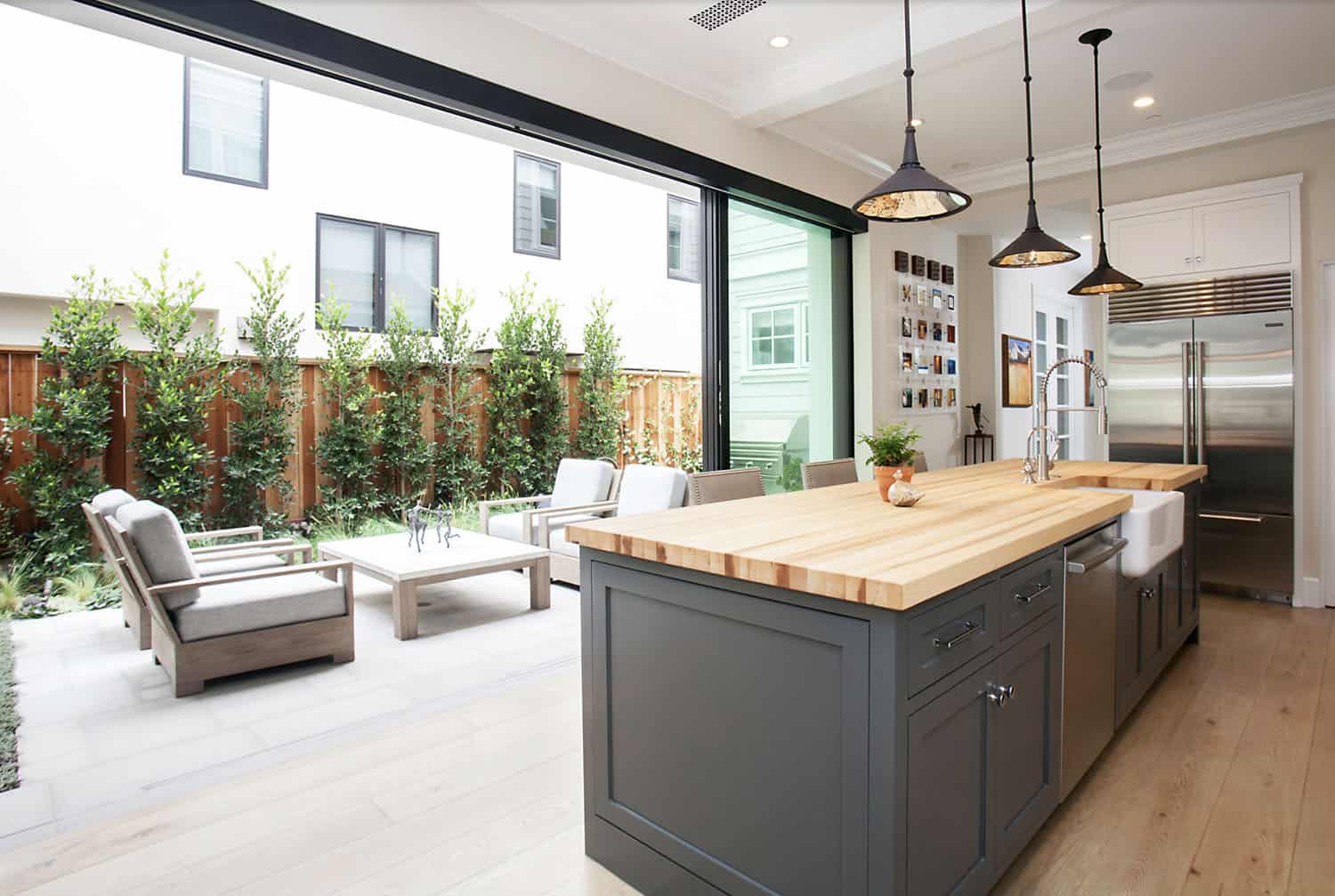 modern farmhouse style kitchen with sliding glass doors leading out to the patio