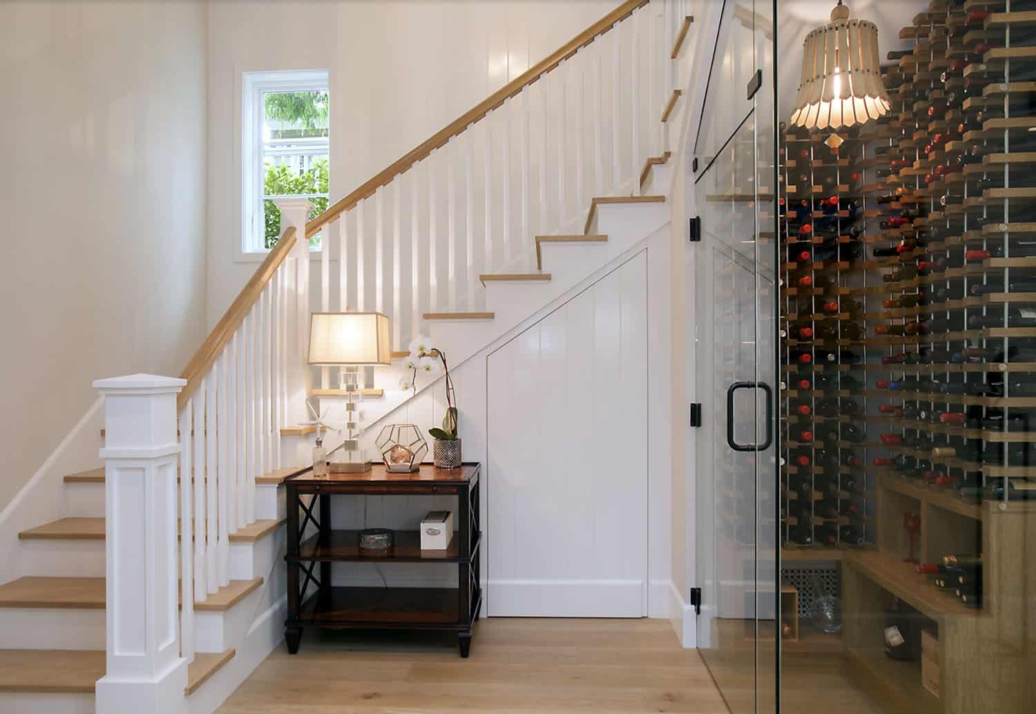 modern farmhouse style staircase with an under stair wine cellar