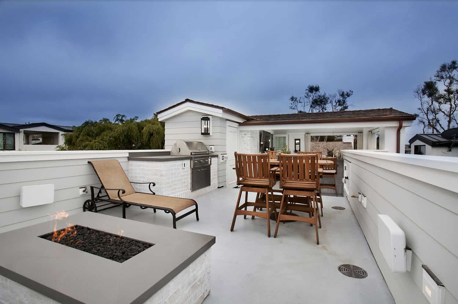 third-floor roof deck with a fire pit and built-in barbecue