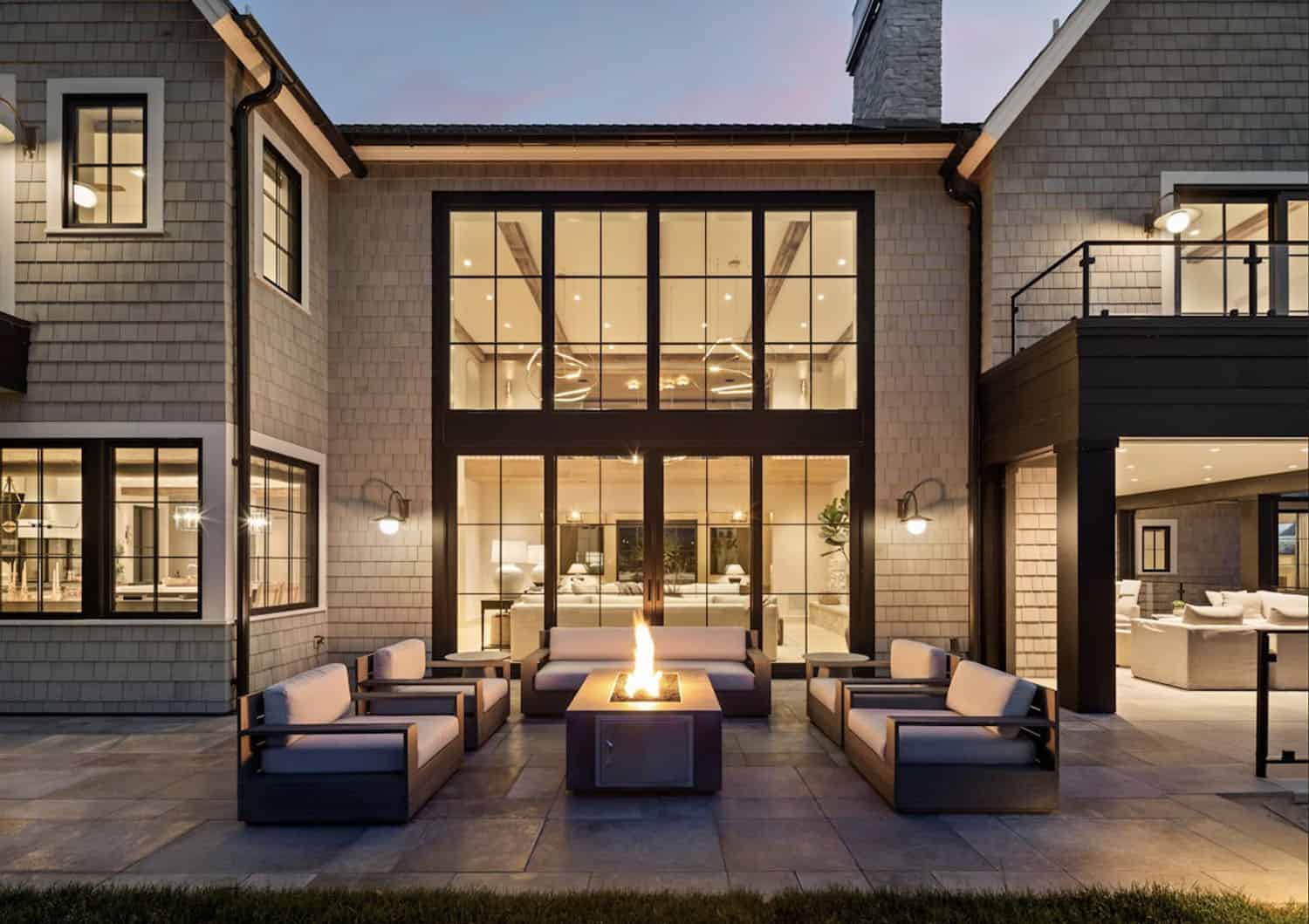 modern lake house exterior with a patio and fire pit