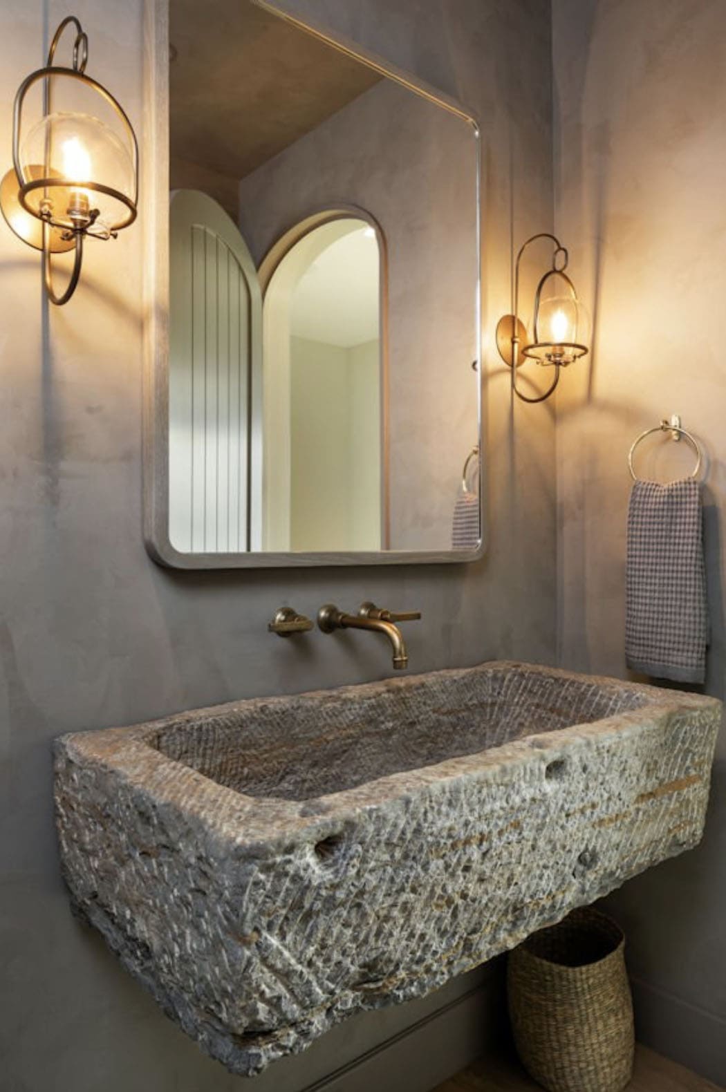 modern powder room with a stone sink