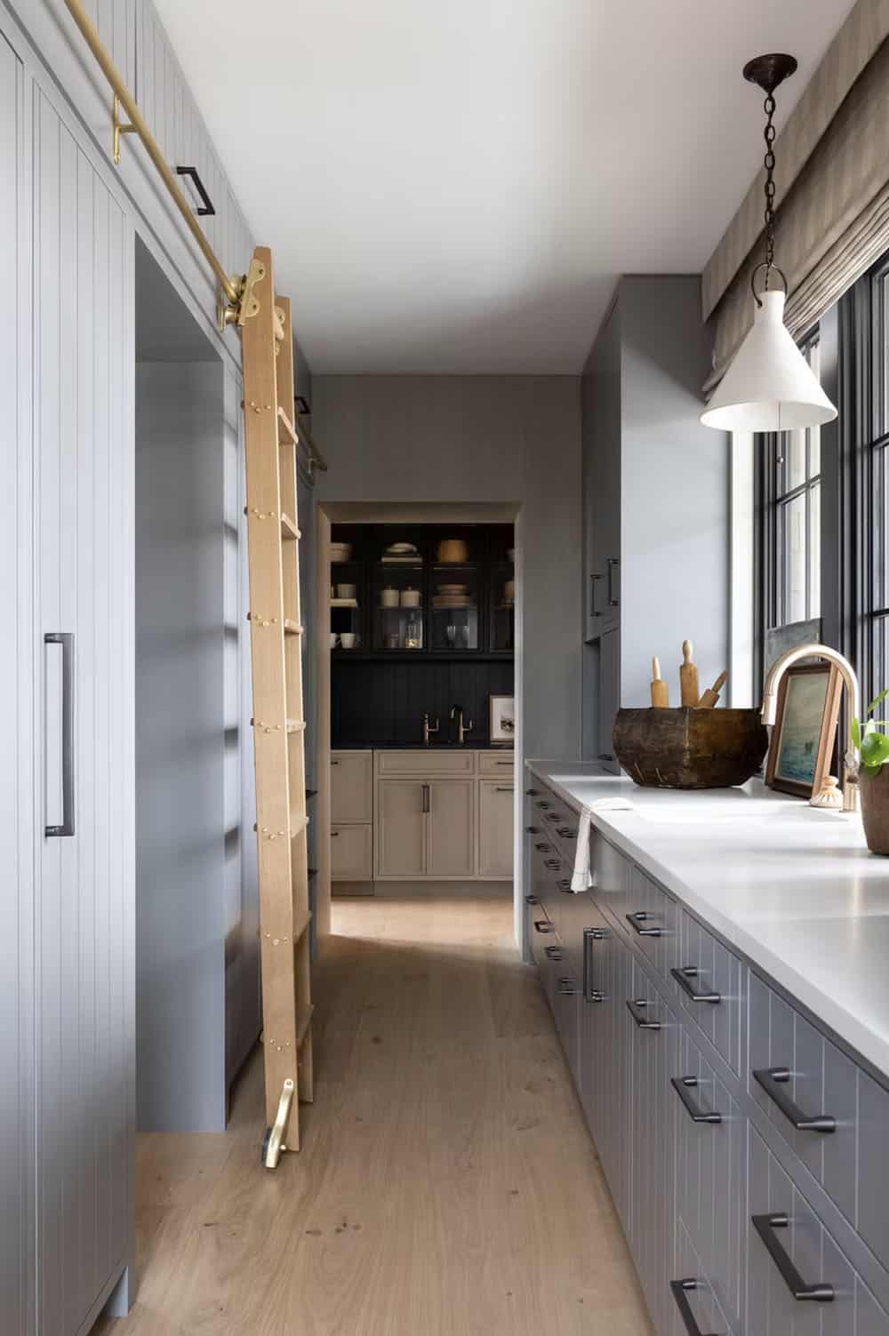 modern kitchen pantry with a rolling ladder