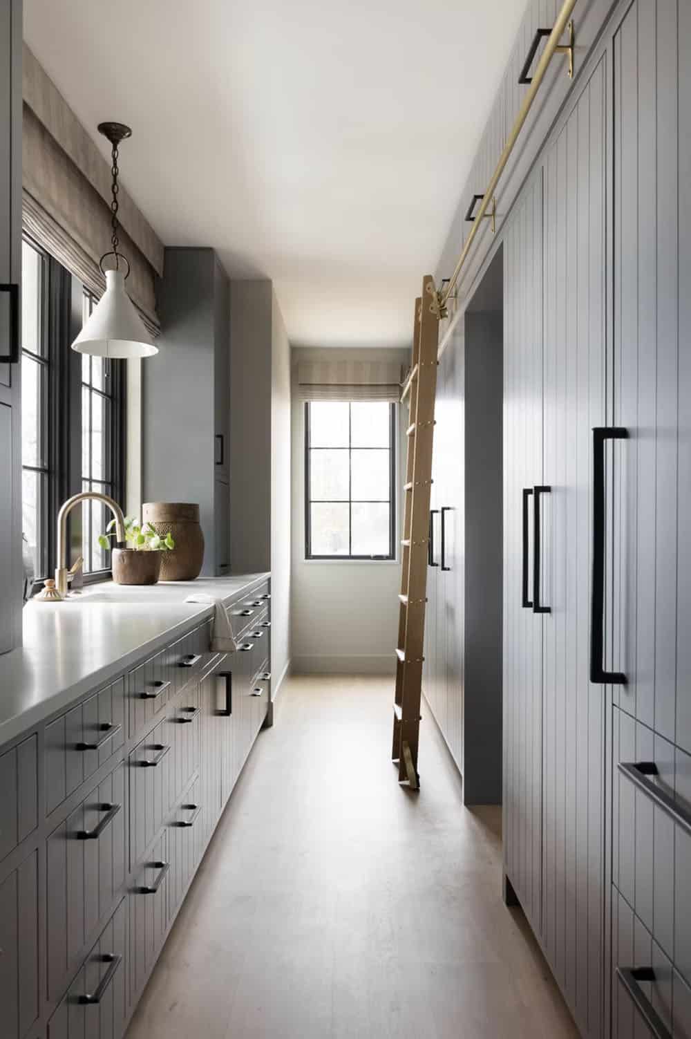 modern kitchen pantry with a rolling ladder