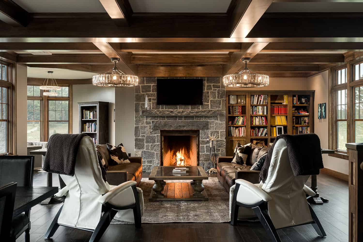 A living room with a fireplace and bookshelves