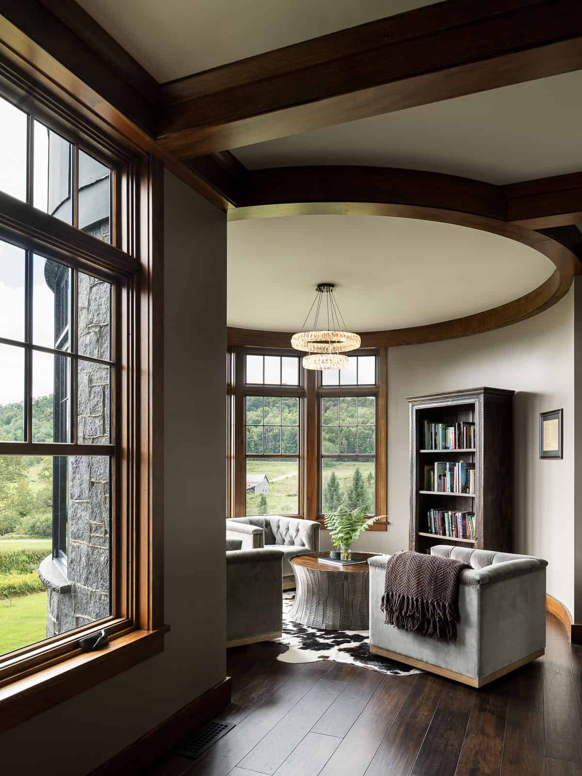 A living room with a large window and wooden floors