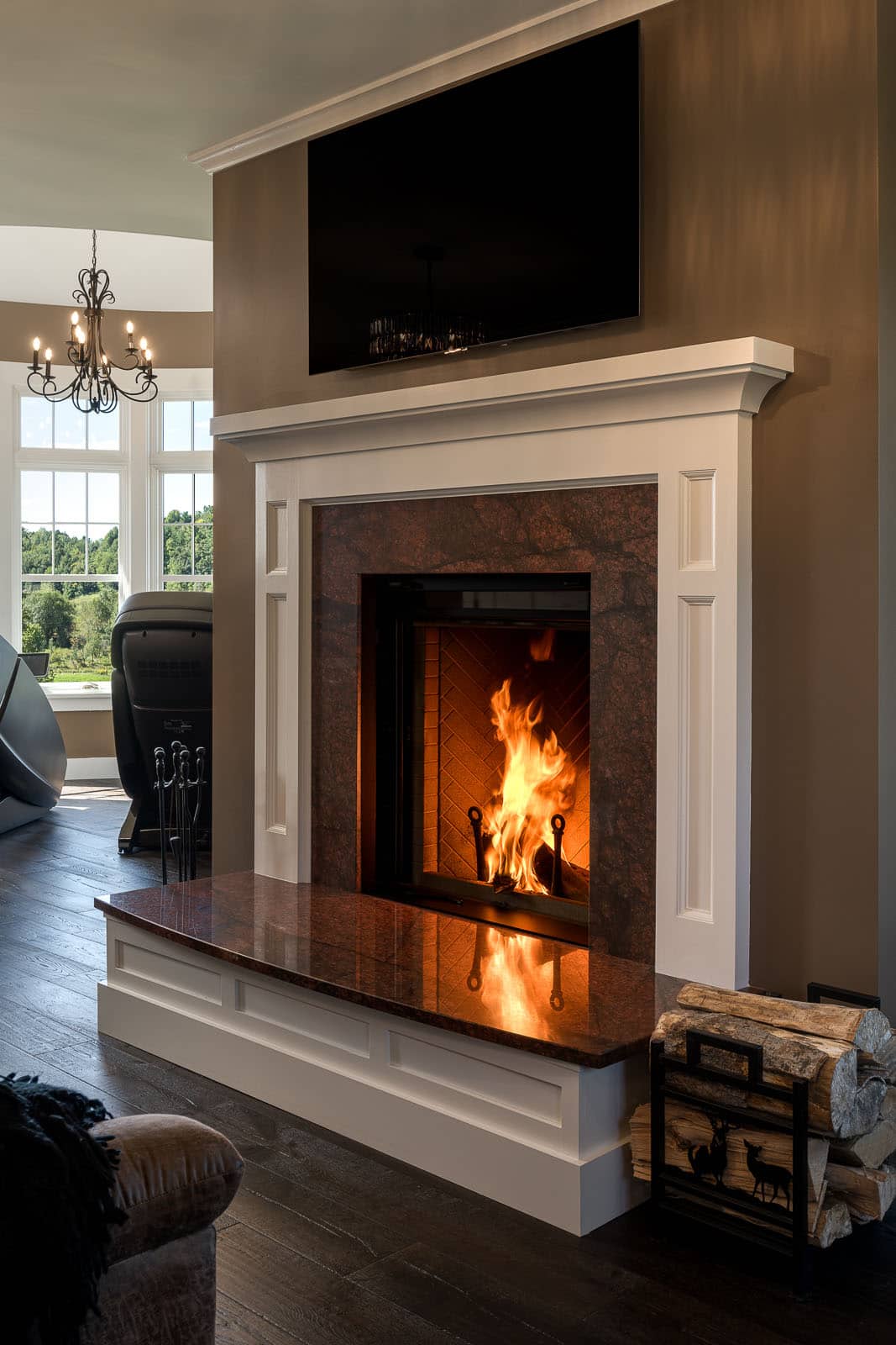 A fireplace in a living room with a television above it