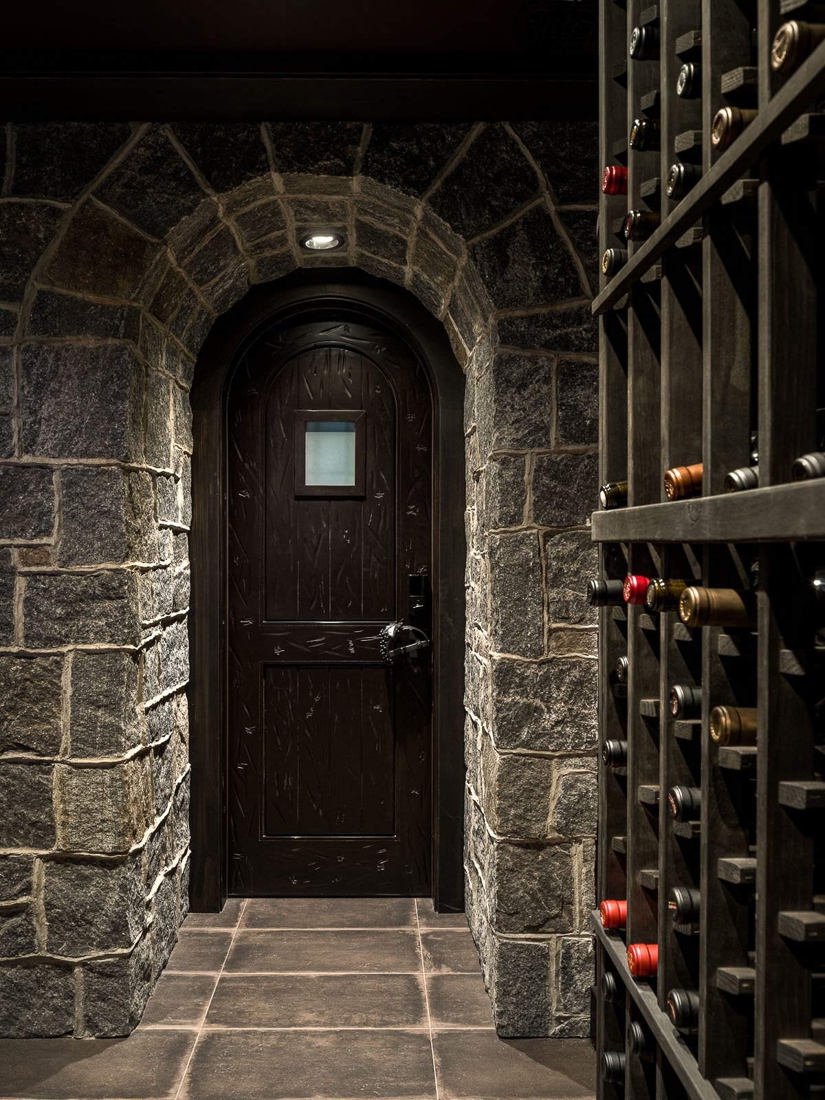 A wine cellar with a door and shelves