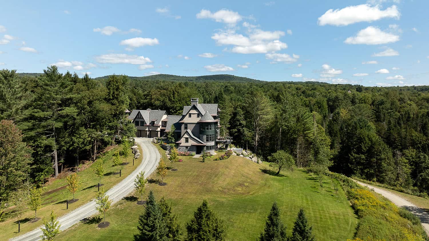 A large mansion surrounded by trees and forest