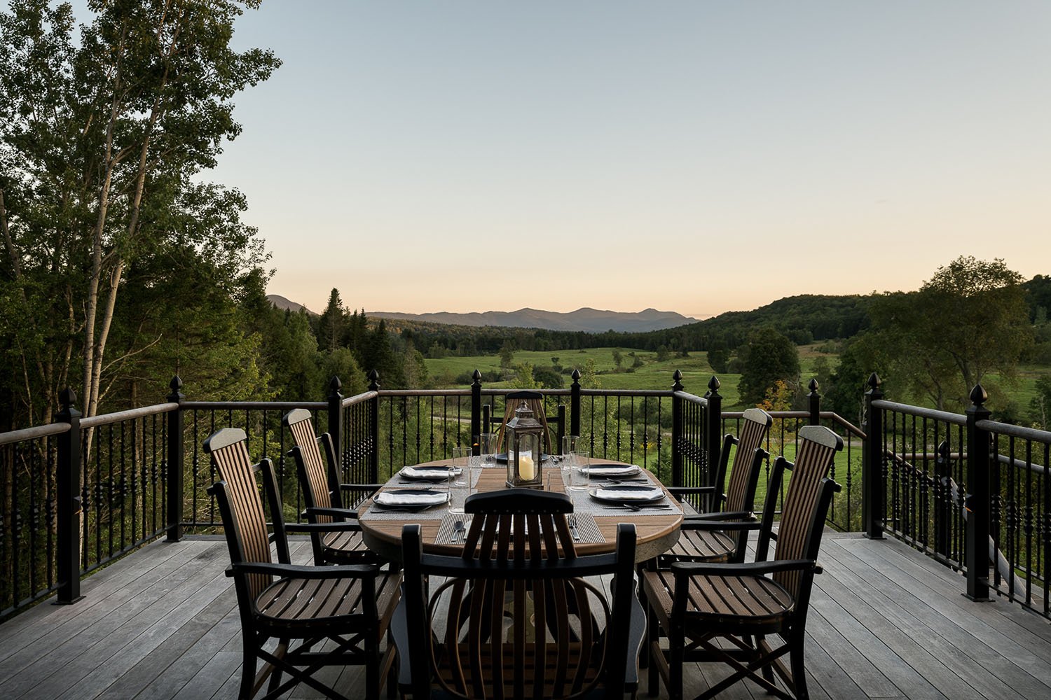 A table set for dinner on a deck overlooking the mountains