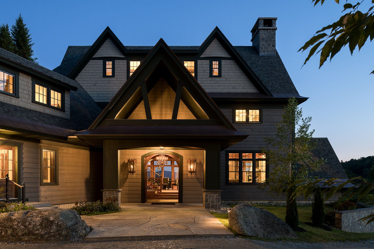 A large home with a stone driveway and a stone walkway leading up to the front door