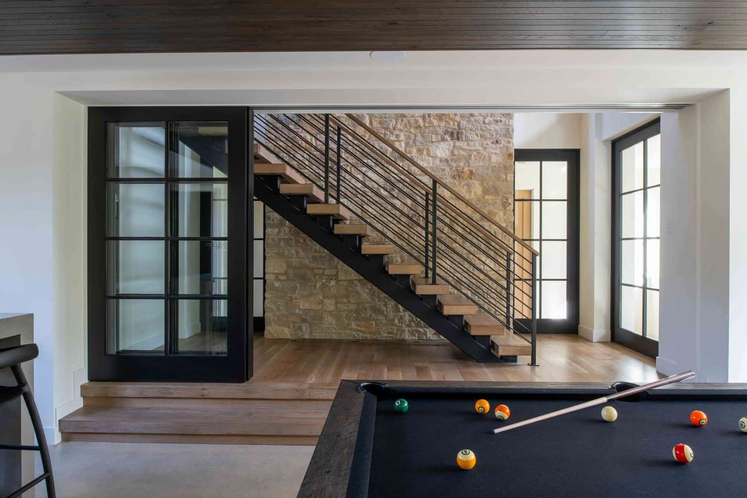 modern modern lower-level family room with a pool table