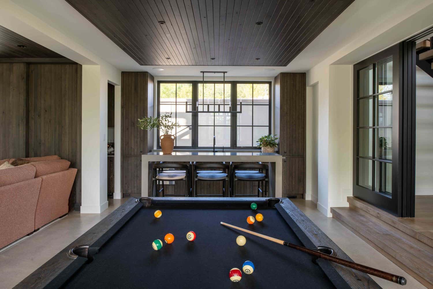modern modern lower-level family room with a pool table