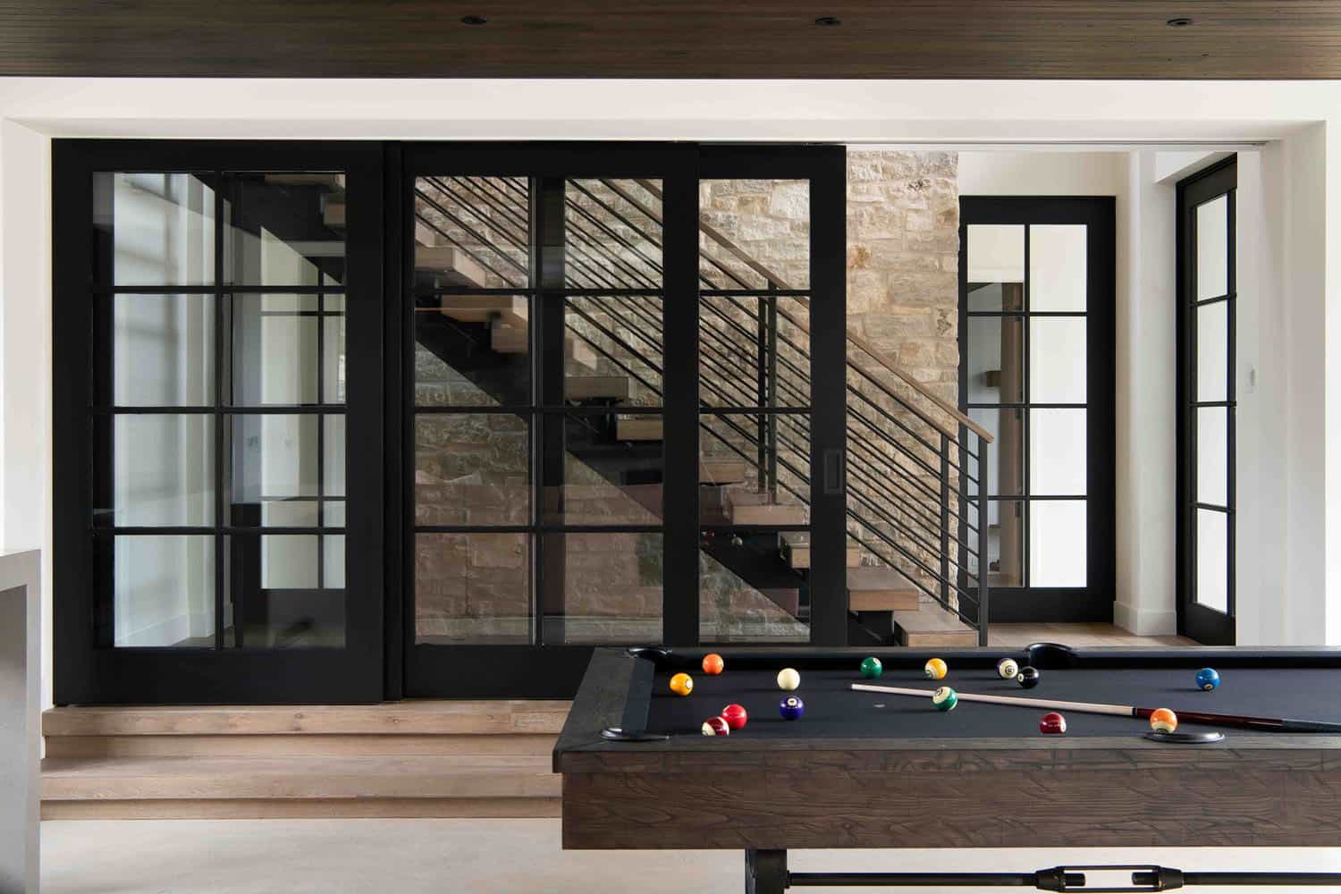 modern modern lower-level family room with a pool table