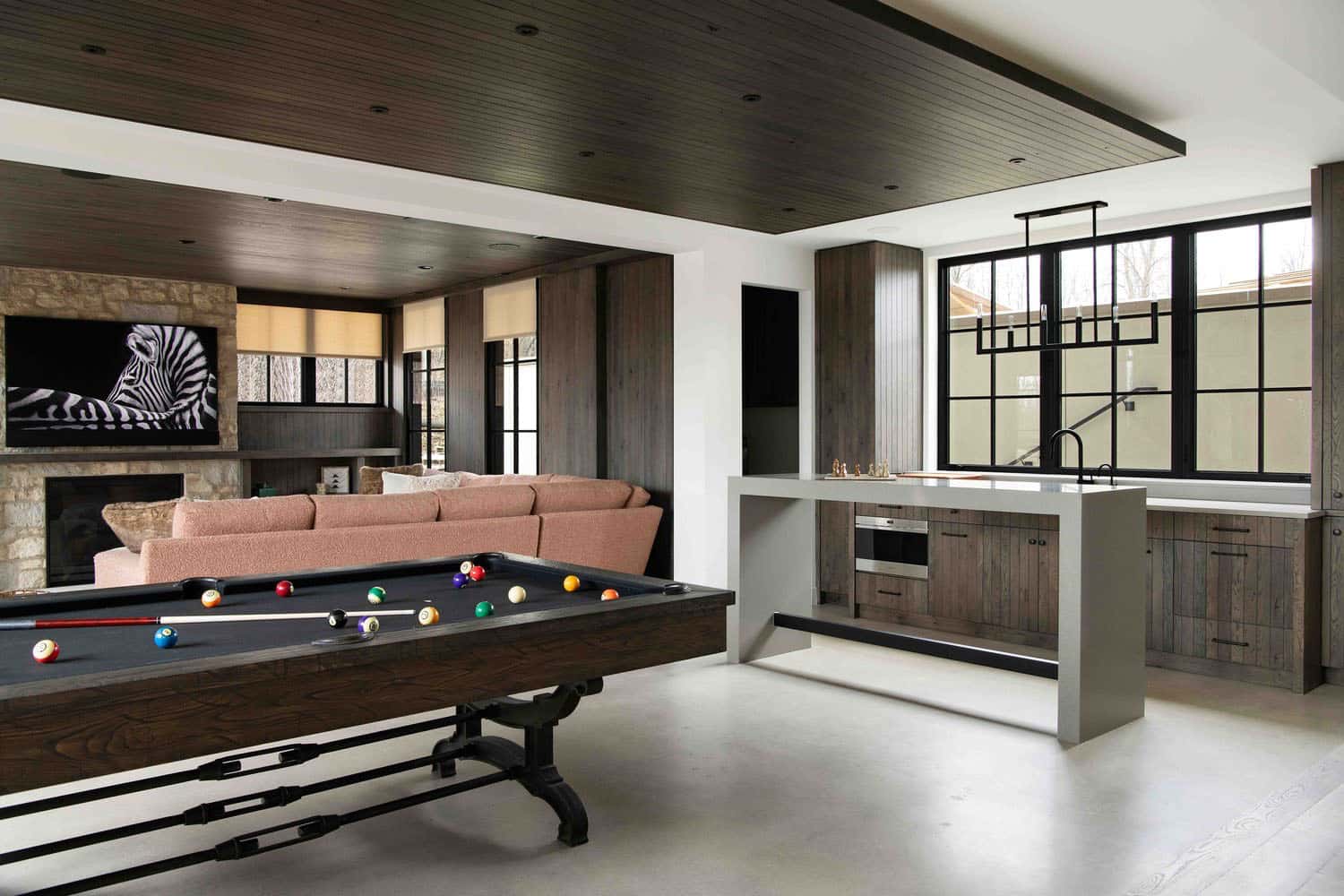 modern modern lower-level family room with a pool table and home bar