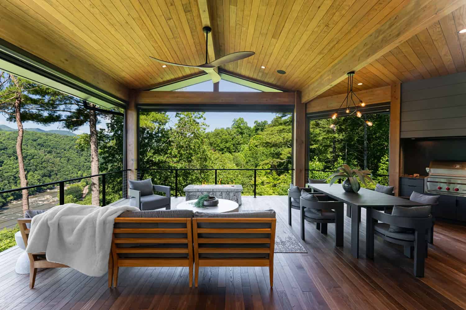 modern covered porch with outdoor furniture and treetop views