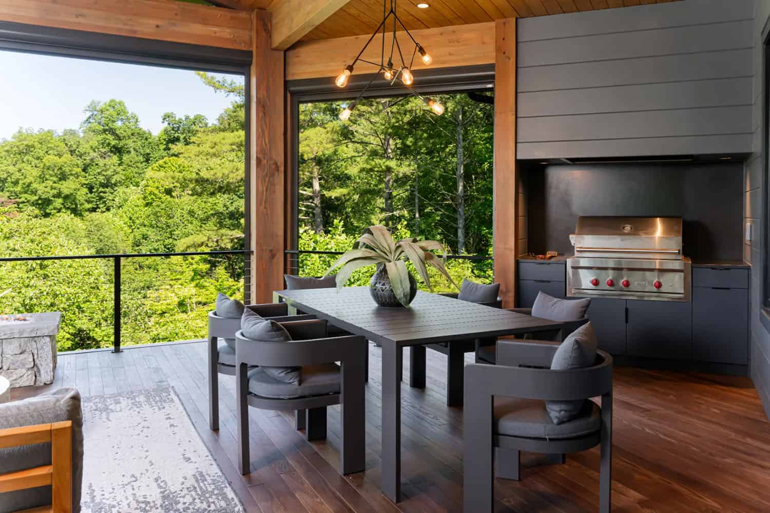 modern covered porch with alfresco dining and treetop views