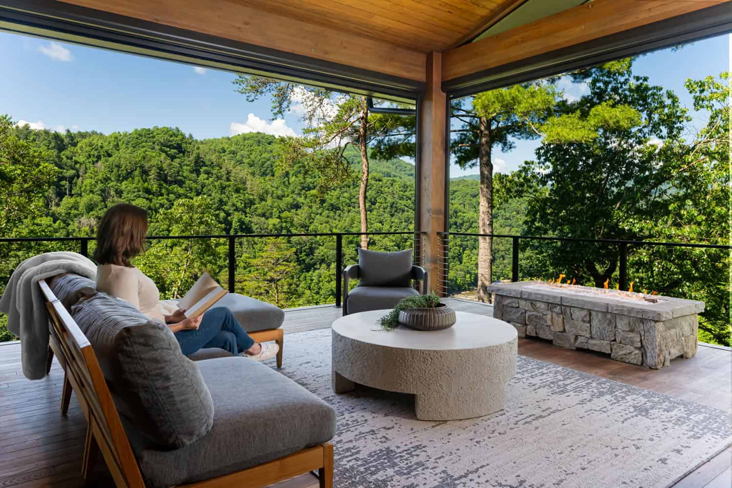 modern covered porch with outdoor furniture and mountain views
