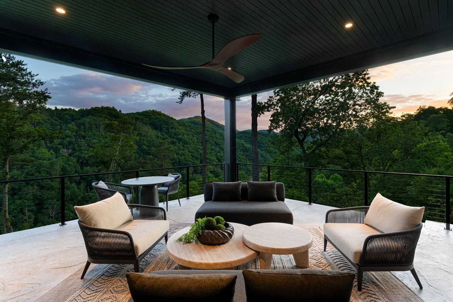modern covered porch with outdoor furniture and mountain views