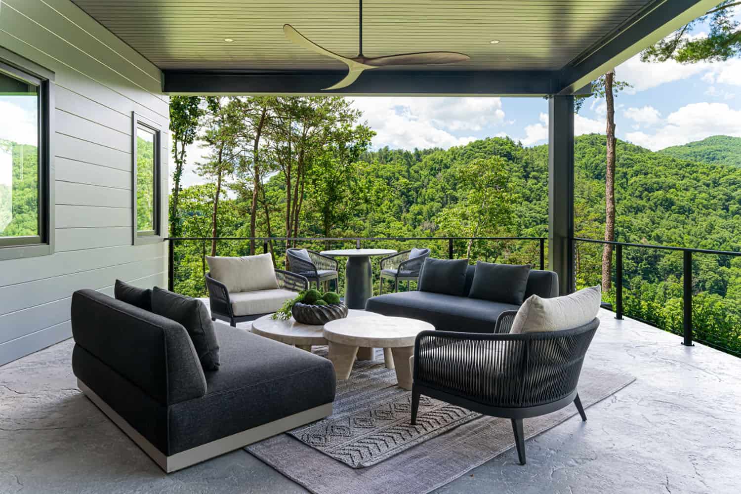modern covered porch with outdoor furniture and mountain views