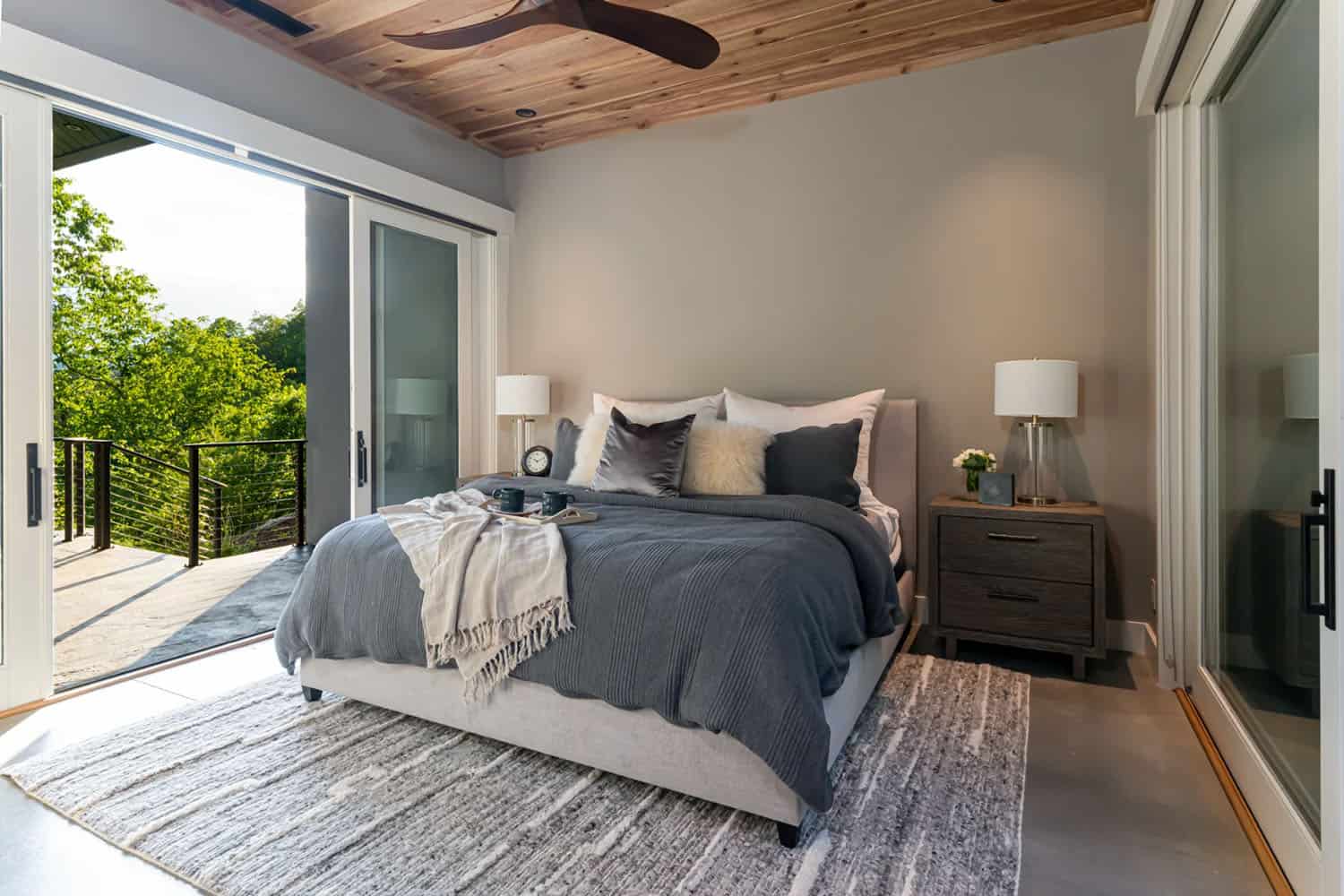 modern bedroom with sliding glass doors leading to a private deck