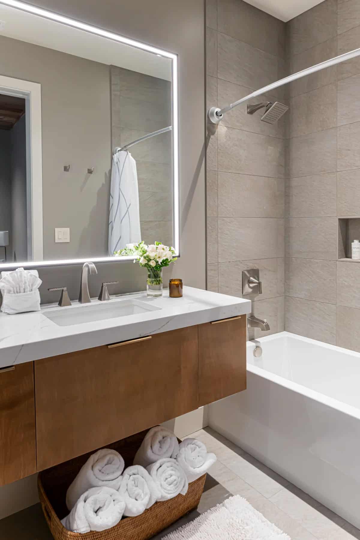 modern bathroom with a vanity and integrated tub