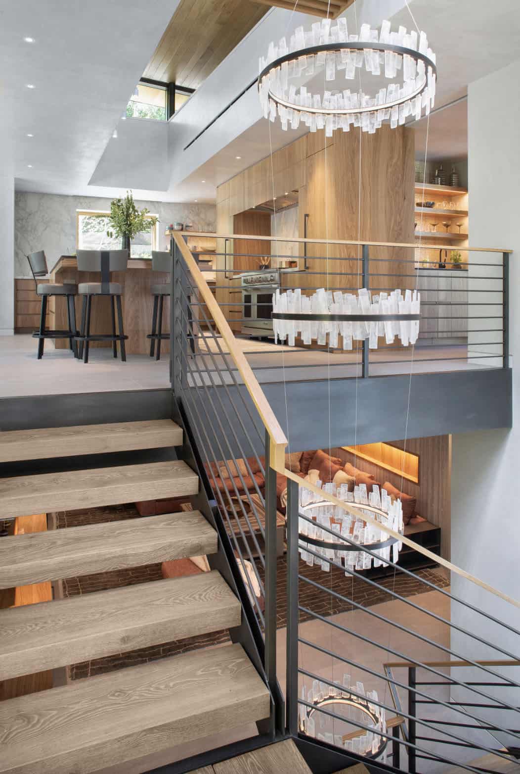 modern staircase with a large chandelier