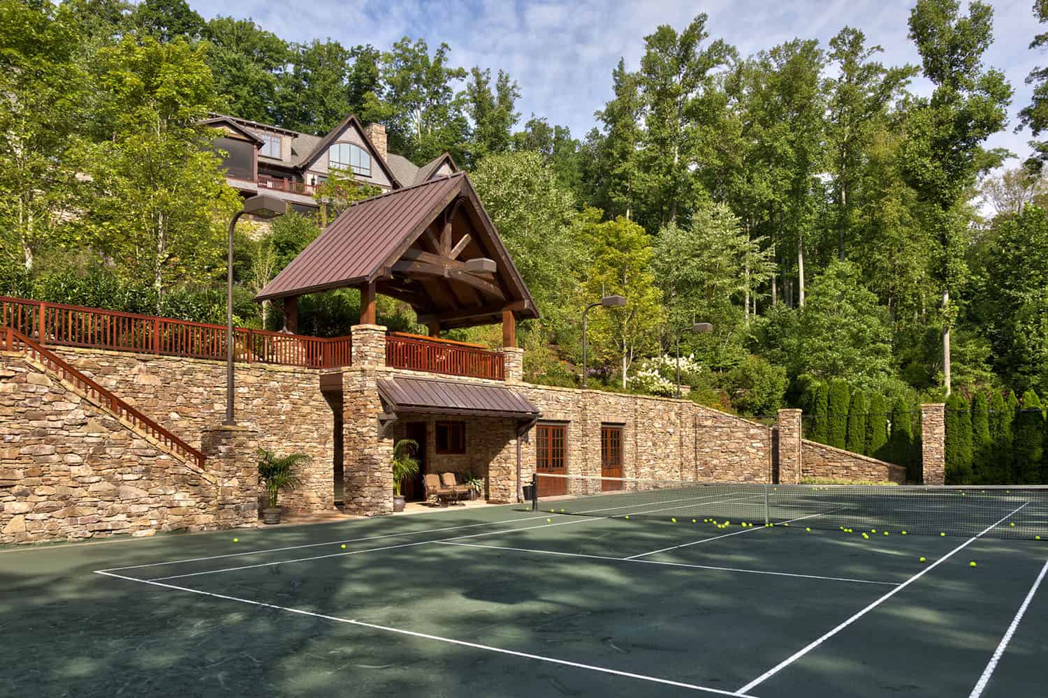 modern rustic mountain home exterior with a tennis court