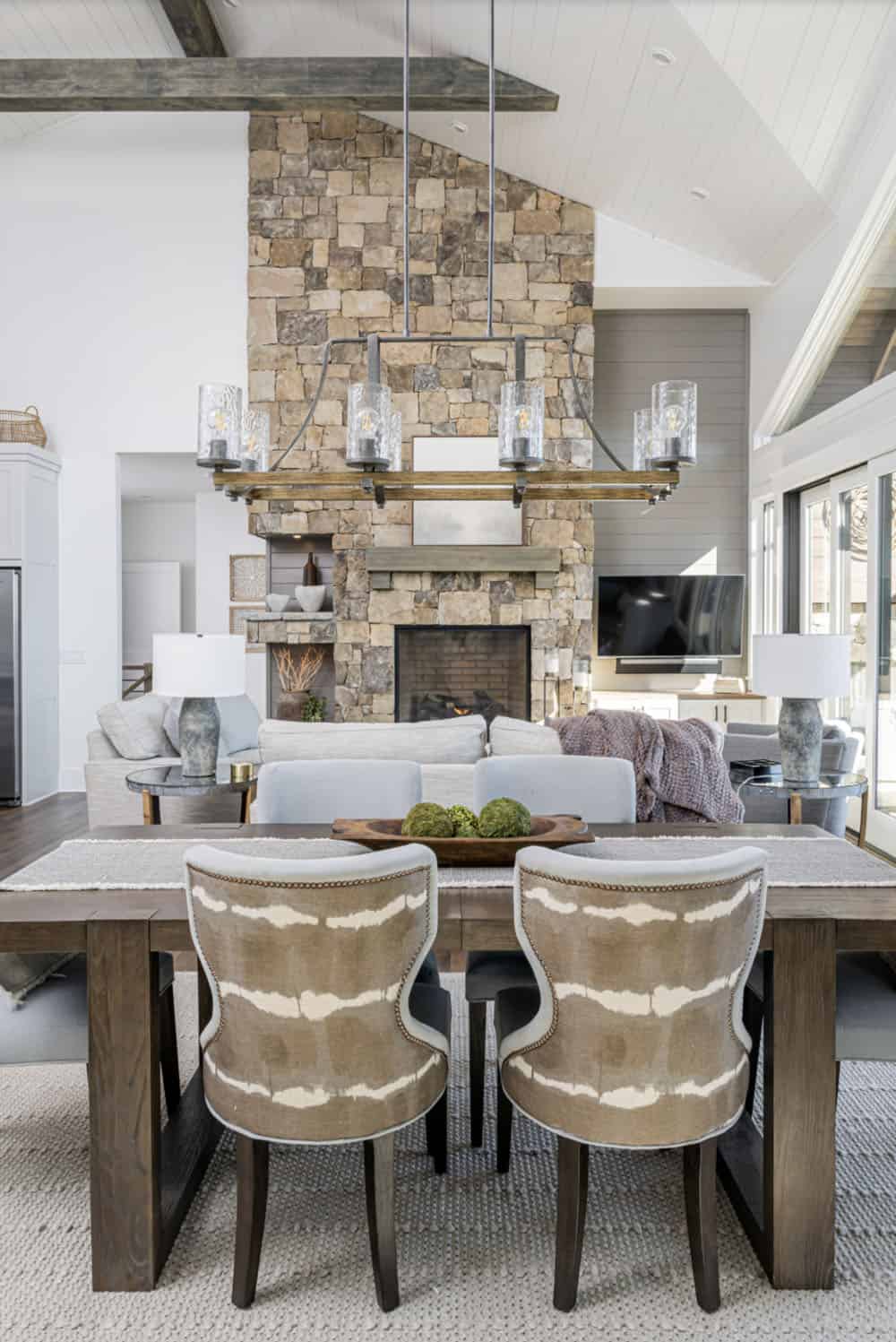 modern rustic dining and living room with a fireplace
