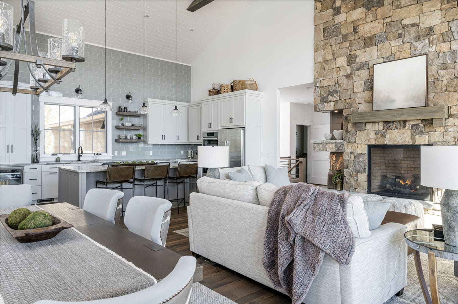 modern rustic dining and living room with a fireplace