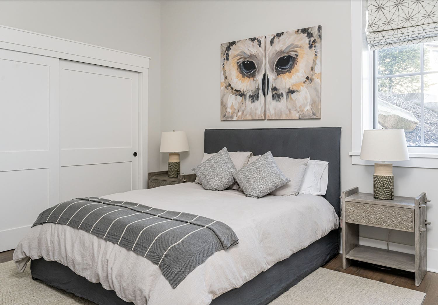 modern rustic bedroom with an owl painting on the wall