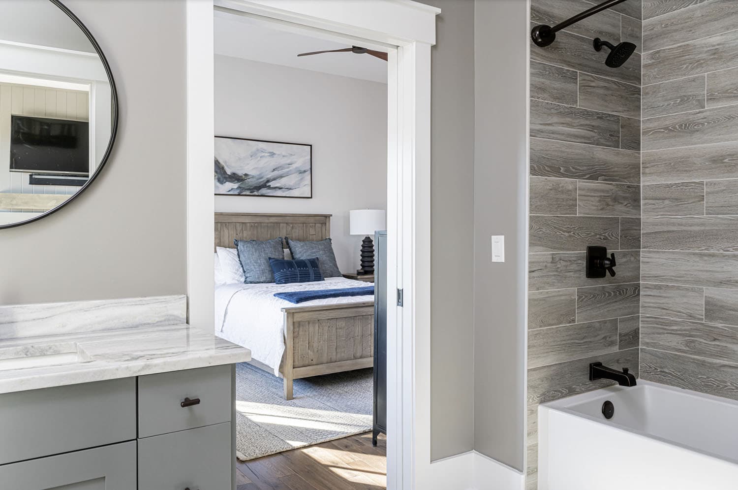 modern rustic bathroom with a view into the en-suite bedroom
