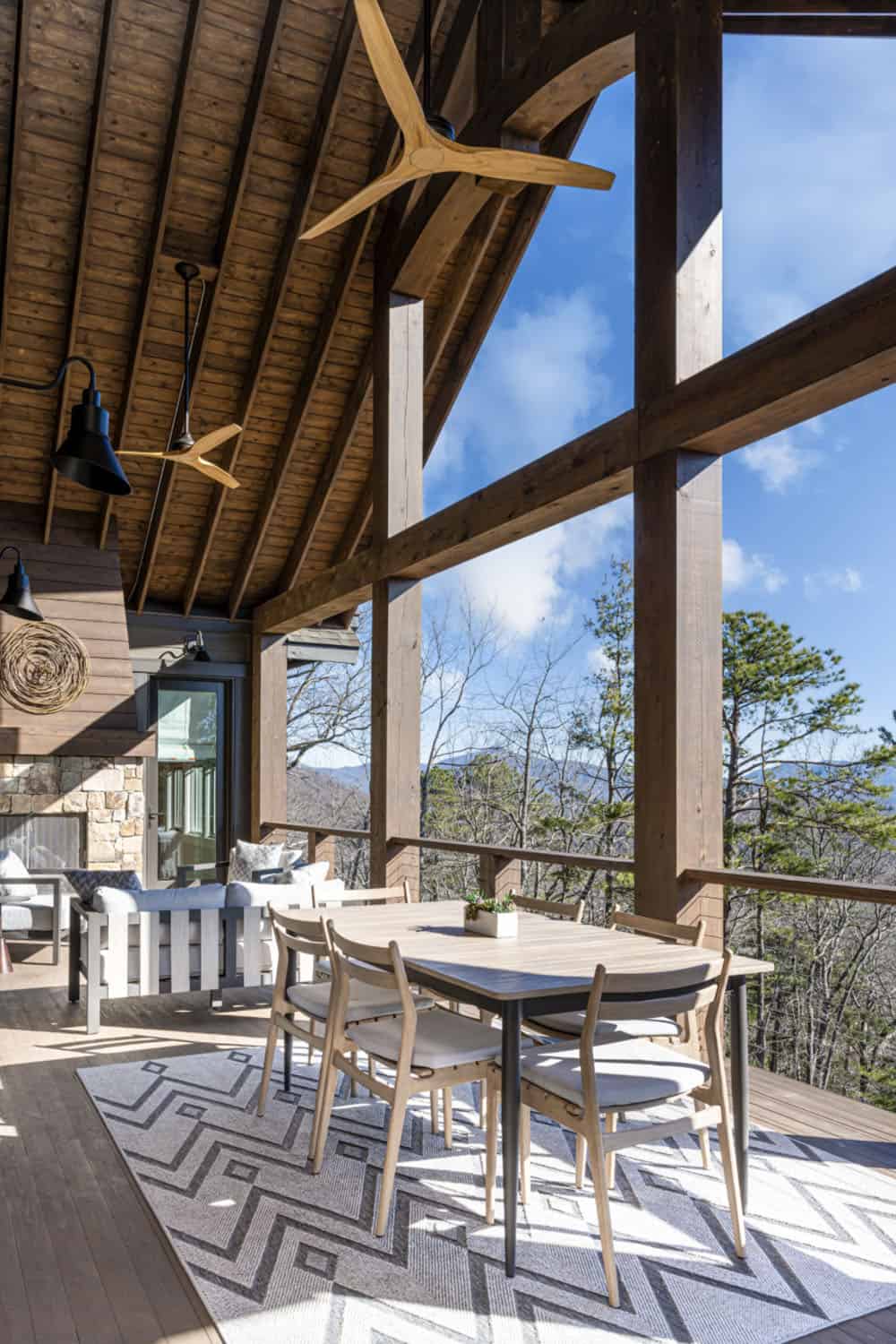 modern rustic mountain home exterior with a covered porch with alfresco dining
