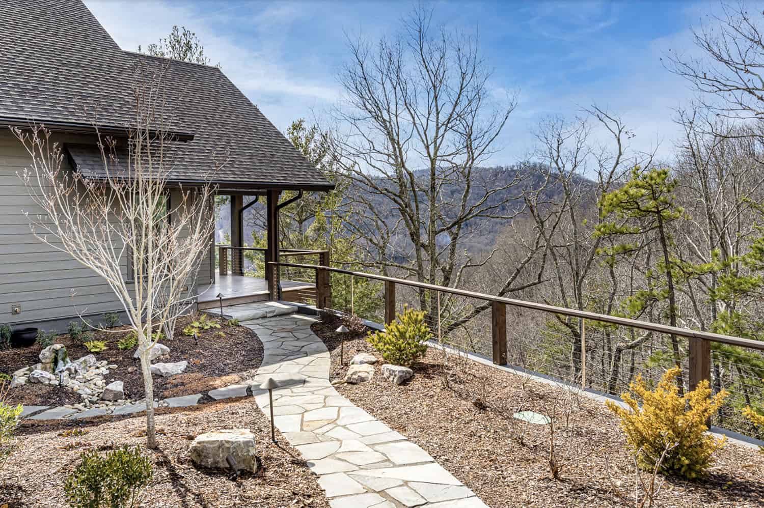 modern rustic mountain home exterior with a walkway
